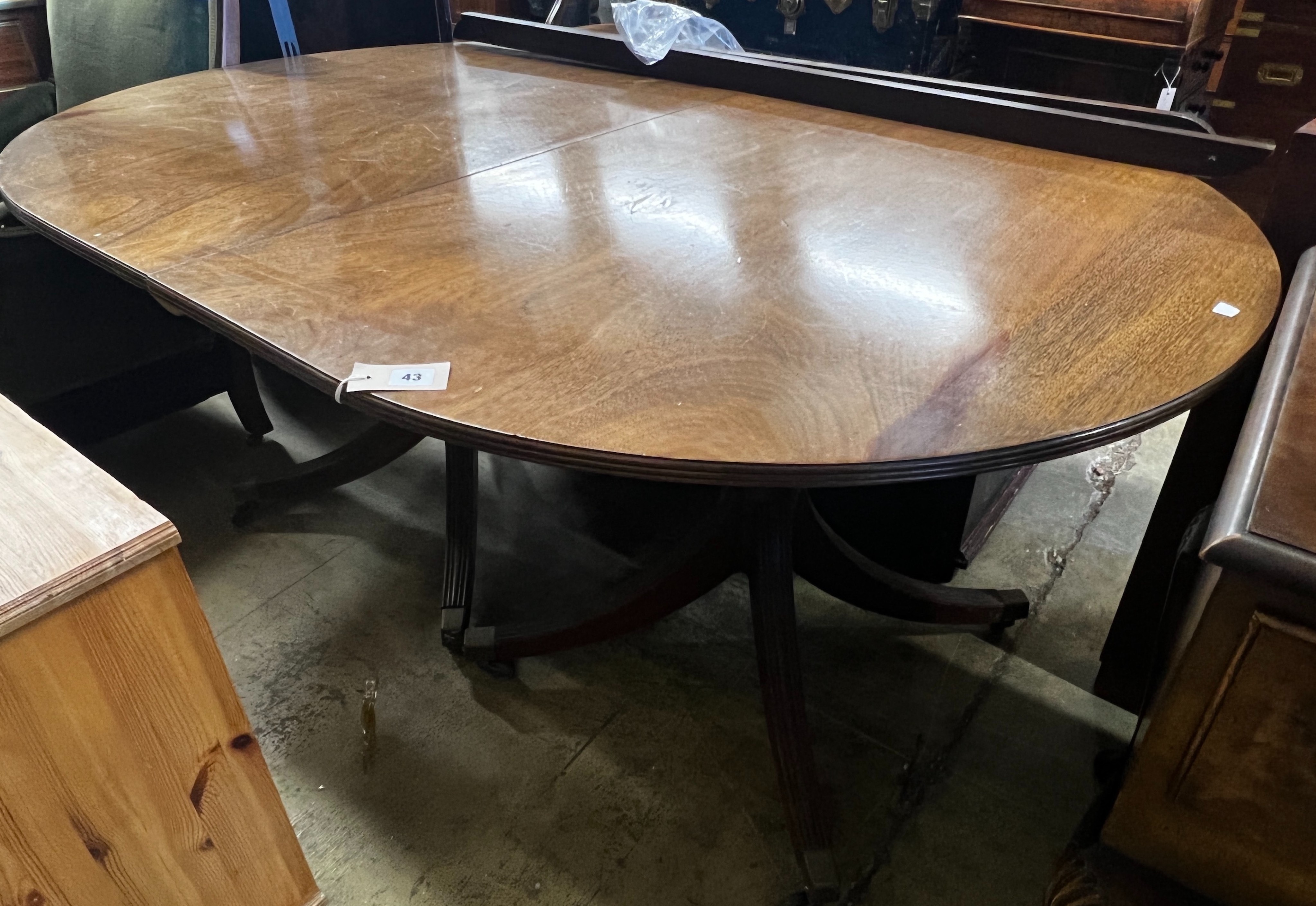 A George III style mahogany twin pedestal D end extending dining table, length 158cm, 248cm extended, two spare leaves, width 110cm, height 72cm
